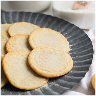 A plate of sugar cookies, representing the final product of a cookie dough fundraiser.